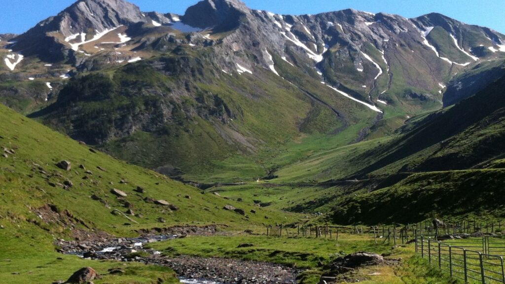 Steep Pyrenees mountains and green valley stream, perfect landscape for mountain hunting in northern Spain