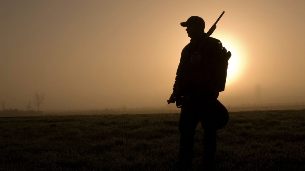Silhouette of a hunter at sunset before wild boar hunting in Spain